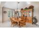 Cozy dining room with wooden table and chairs, complemented by a hutch at 1479 Short Grass Ct, Castle Rock, CO 80109