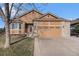 Charming home with a two-car garage, brick accents, and well-maintained lawn at 1479 Short Grass Ct, Castle Rock, CO 80109