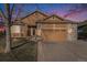 Charming home with a two-car garage, brick accents, and well-maintained lawn at 1479 Short Grass Ct, Castle Rock, CO 80109