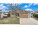 Charming home boasts a well-manicured lawn and a two-car garage at 1479 Short Grass Ct, Castle Rock, CO 80109