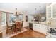 Open-concept kitchen with a dining area, granite countertops, and hardwood floors at 1479 Short Grass Ct, Castle Rock, CO 80109