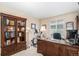 Well-lit office features a large desk, shelving unit, and ample workspace at 1479 Short Grass Ct, Castle Rock, CO 80109