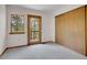 Bright bedroom with natural light, closet, and a view to the forest at 5336 High Rd, Evergreen, CO 80439