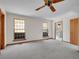 Spacious bedroom with soft carpet, two windows, and ceiling fan at 5336 High Rd, Evergreen, CO 80439