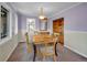 Charming dining room with wainscoting, built in cabinets, and a large window at 5336 High Rd, Evergreen, CO 80439