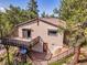 Exterior of home featuring a balcony, stone foundation and steps up to the entrance at 5336 High Rd, Evergreen, CO 80439