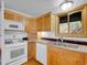 Eat-in kitchen features wooden cabinets, stainless sink, and ample counter space at 5336 High Rd, Evergreen, CO 80439