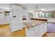 Bright kitchen with white refrigerator and a breakfast bar with forest views at 5336 High Rd, Evergreen, CO 80439