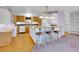 Charming kitchen with wood cabinets, central island, and bar stool seating at 5336 High Rd, Evergreen, CO 80439