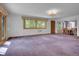Bright living room featuring carpet, natural light, and open floor plan at 5336 High Rd, Evergreen, CO 80439