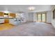 Bright living room with built-in shelving, french doors, and kitchen access at 5336 High Rd, Evergreen, CO 80439