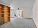 Bright living room features neutral carpet, ceiling fan, and built-in shelving at 5336 High Rd, Evergreen, CO 80439