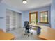 Inviting home office with custom built-in desk, shelving, and a view at 5336 High Rd, Evergreen, CO 80439
