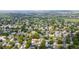 An aerial view shows a neighborhood filled with lush green trees and houses, blending seamlessly into the landscape at 10563 Pierson Cir, Broomfield, CO 80021