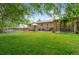 Expansive backyard featuring lush green grass, a covered patio area, perfect for outdoor entertaining and relaxation at 10563 Pierson Cir, Broomfield, CO 80021