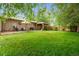 Spacious backyard featuring a lush lawn, patio, outdoor seating, grill, and an inviting covered pergola area at 10563 Pierson Cir, Broomfield, CO 80021