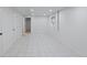 Spacious basement with white tile flooring, white walls, and good lighting at 10563 Pierson Cir, Broomfield, CO 80021