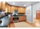 Bright kitchen featuring wood cabinets, stainless steel appliances, and a view of the backyard at 10563 Pierson Cir, Broomfield, CO 80021