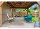 Covered patio with a rocking chair, couch, and hanging plants for outdoor relaxation at 10563 Pierson Cir, Broomfield, CO 80021