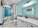 Modern bathroom with blue walls and a walk-in shower at 6610 S Waco Way, Aurora, CO 80016