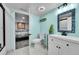 Basement bathroom with white vanity, mosaic mirror, and shower at 6610 S Waco Way, Aurora, CO 80016