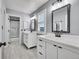 Bathroom with white double vanity and gray walls at 6610 S Waco Way, Aurora, CO 80016