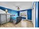 Blue-themed bedroom with Star Wars decor and wood floors at 6610 S Waco Way, Aurora, CO 80016