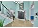 Bright entryway with hardwood floors, staircase, and high ceilings at 6610 S Waco Way, Aurora, CO 80016