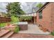 Relax in this brick home's backyard with a hot tub and covered patio area at 770 Locust, Denver, CO 80220