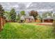 Well-manicured lawn and covered patio area grace this brick home's backyard at 770 Locust, Denver, CO 80220