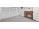 Finished basement with built-in shelving, brick fireplace, and neutral carpet for a cozy living space at 770 Locust, Denver, CO 80220