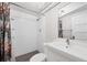 Simple bathroom featuring a sink, toilet, and shower with white tiles and floral curtains at 770 Locust, Denver, CO 80220