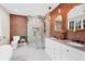 Bathroom with brick accent wall, granite countertops and a glass shower enclosure at 770 Locust, Denver, CO 80220