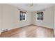 Bright bedroom with hardwood floors, two windows and white trim creating a calm and inviting atmosphere at 770 Locust, Denver, CO 80220