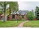 Charming brick home with a well-maintained lawn and beautiful landscaping at 770 Locust, Denver, CO 80220