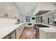 Modern, all-white kitchen with stainless steel appliances and hardwood floors at 770 Locust, Denver, CO 80220