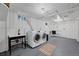 Well-lit laundry room with modern washer and dryer, sink, and storage space for added convenience at 770 Locust, Denver, CO 80220