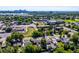 Areal view of a neighborhood with green spaces, a body of water and a city skyline under a light, blue sky at 1955 Ingalls St, Lakewood, CO 80214