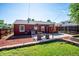 Backyard featuring patio with pergola, retaining wall, and view of house exterior at 1955 Ingalls St, Lakewood, CO 80214