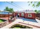 Backyard featuring patio with pergola, retaining wall, and house exterior at 1955 Ingalls St, Lakewood, CO 80214