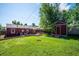 Large backyard featuring a shed, patio, and manicured lawn at 1955 Ingalls St, Lakewood, CO 80214