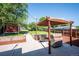 Landscaped backyard featuring patio, stylish pergola with seating, manicured lawn and privacy fence at 1955 Ingalls St, Lakewood, CO 80214