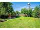 Spacious backyard with green lawn, shed, and wooden fence at 1955 Ingalls St, Lakewood, CO 80214