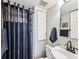 Bathroom featuring a shower with a stylish curtain, neutral walls, and modern fixtures at 1955 Ingalls St, Lakewood, CO 80214