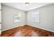 Bedroom with hardwood floors, two windows that allow natural light and fresh paint at 1955 Ingalls St, Lakewood, CO 80214
