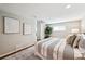 Bedroom with hardwood floors, grey walls, art, and a decorative plant by the window at 1955 Ingalls St, Lakewood, CO 80214