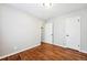 Spacious bedroom featuring gleaming hardwood floors and convenient access to closet and hallway at 1955 Ingalls St, Lakewood, CO 80214