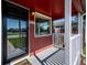 Cozy front porch with white pillars and view of a well-kept lawn and nearby street at 1955 Ingalls St, Lakewood, CO 80214