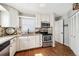 Bright kitchen with white cabinets, granite countertops, stainless steel appliances, and hardwood floors at 1955 Ingalls St, Lakewood, CO 80214