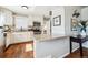 Modern kitchen with white cabinets, stainless steel appliances, and an adjacent dining area at 1955 Ingalls St, Lakewood, CO 80214
